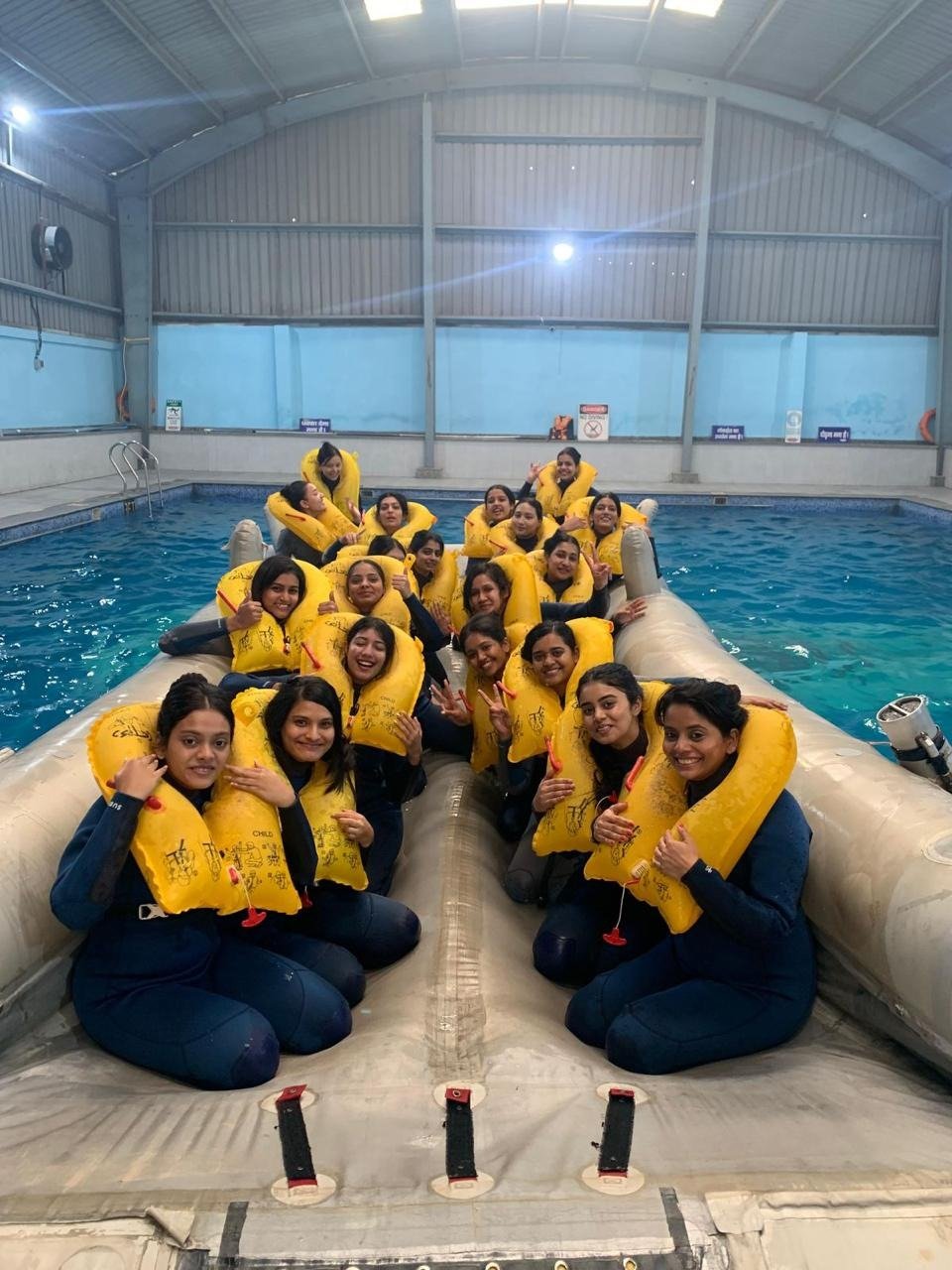 Students on a life raft during emergency evacuation training